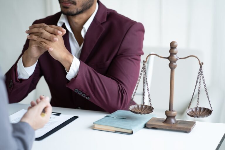 Young professional lawyer consulting with his client, listening to client situation about the case.